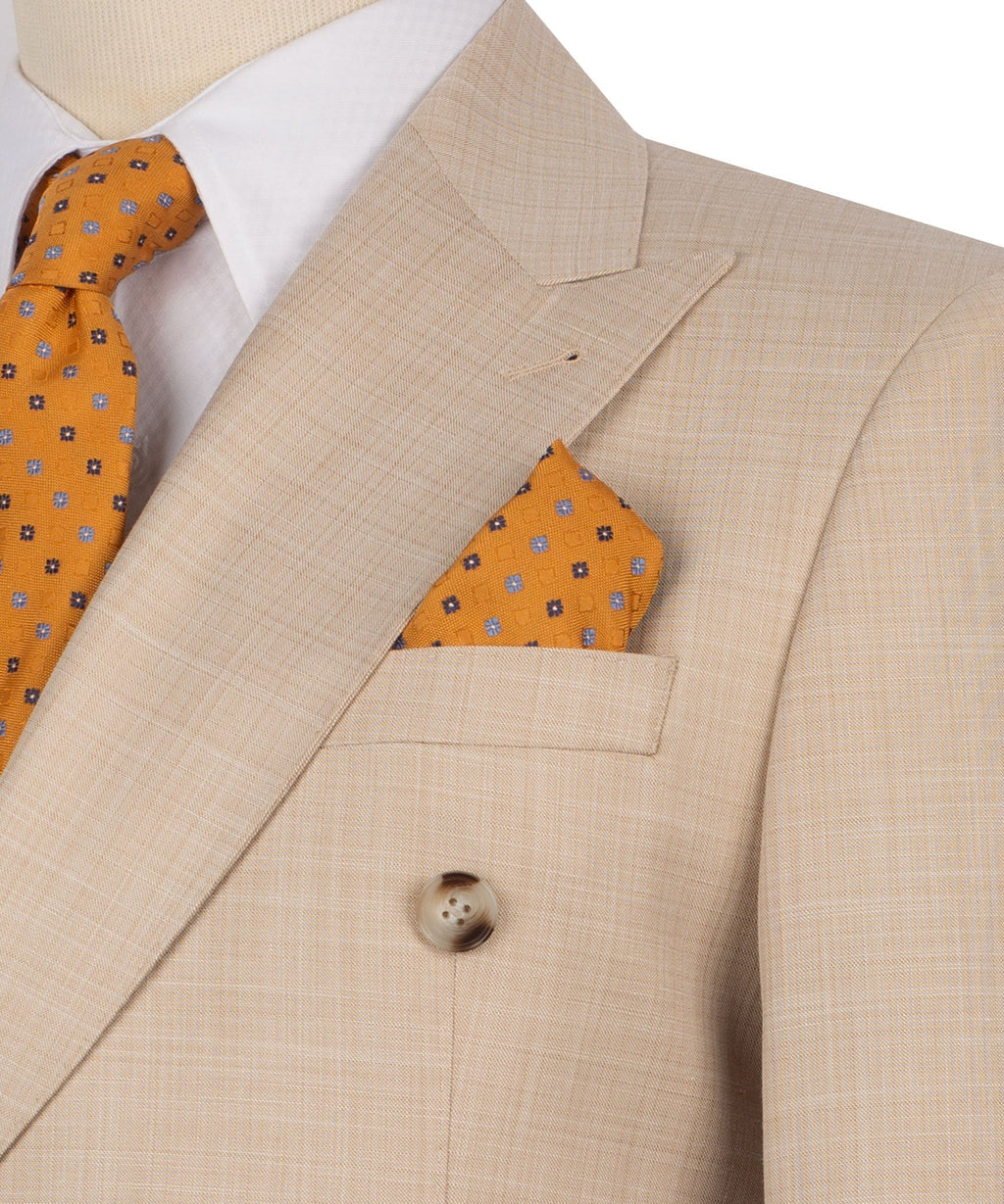 Close-up of light brown blazer lapel and pocket with orange patterned pocket square