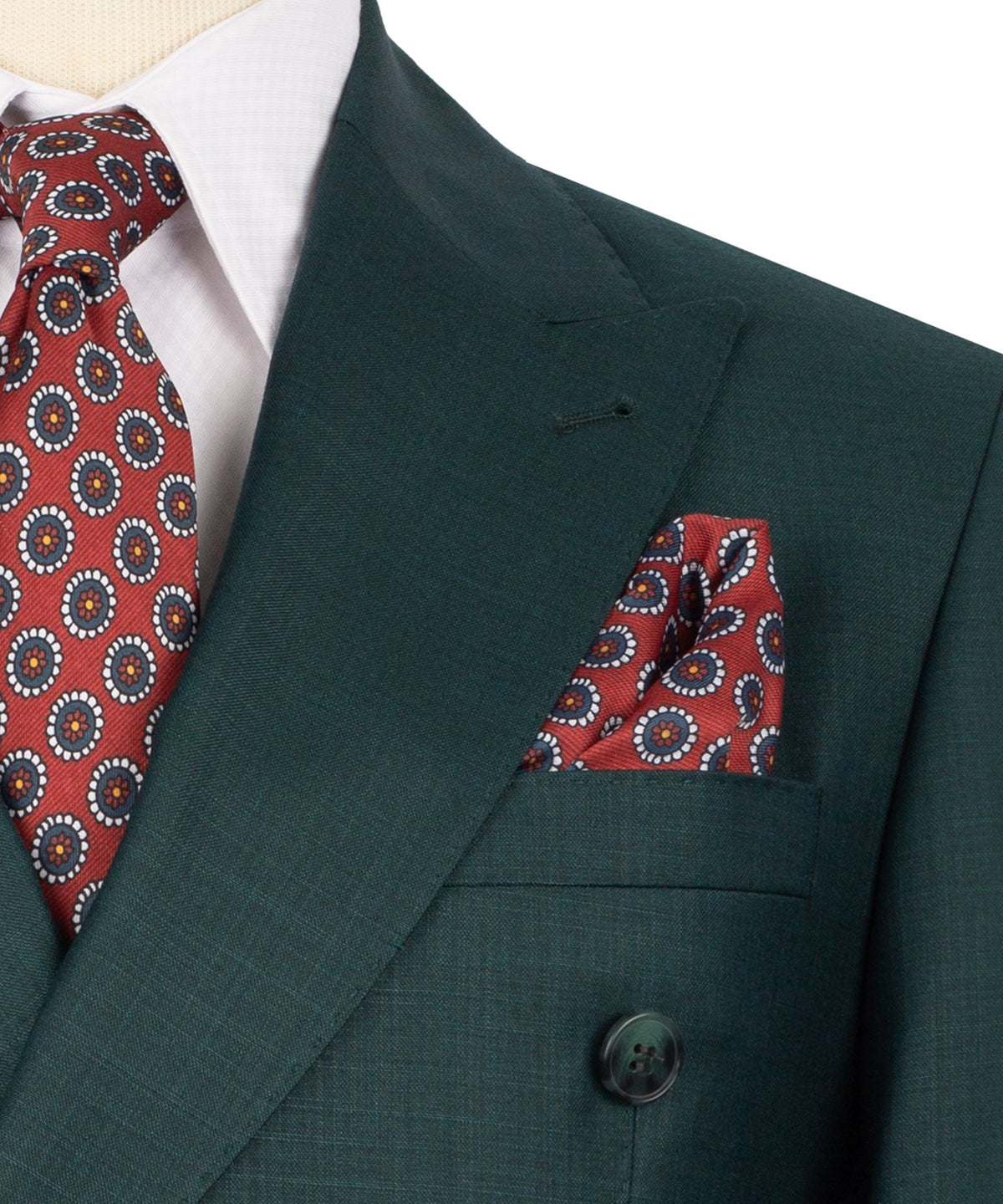 Green suit jacket lapel with red patterned pocket square detail