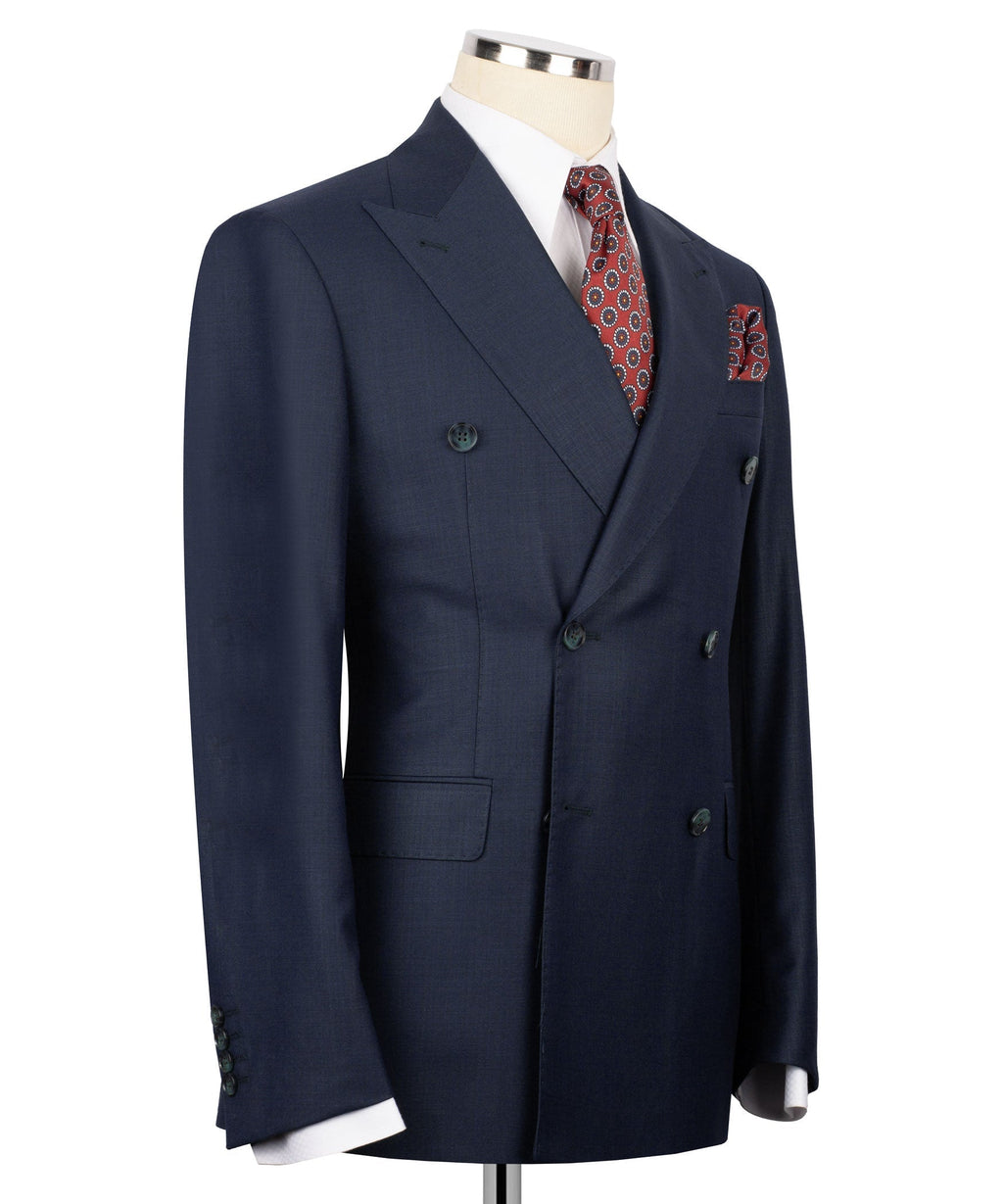 Navy double-breasted suit jacket on mannequin with patterned pocket square and side vents