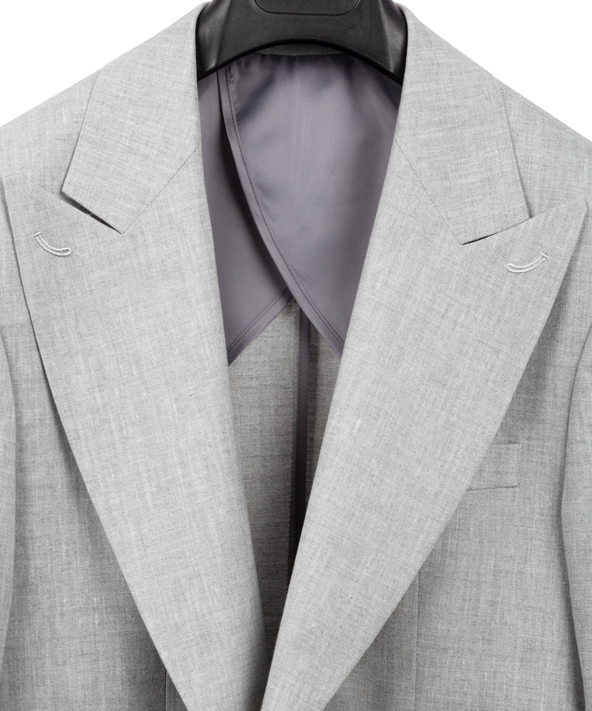 Light gray linen suit blazer with open front showing dark lining at the chest