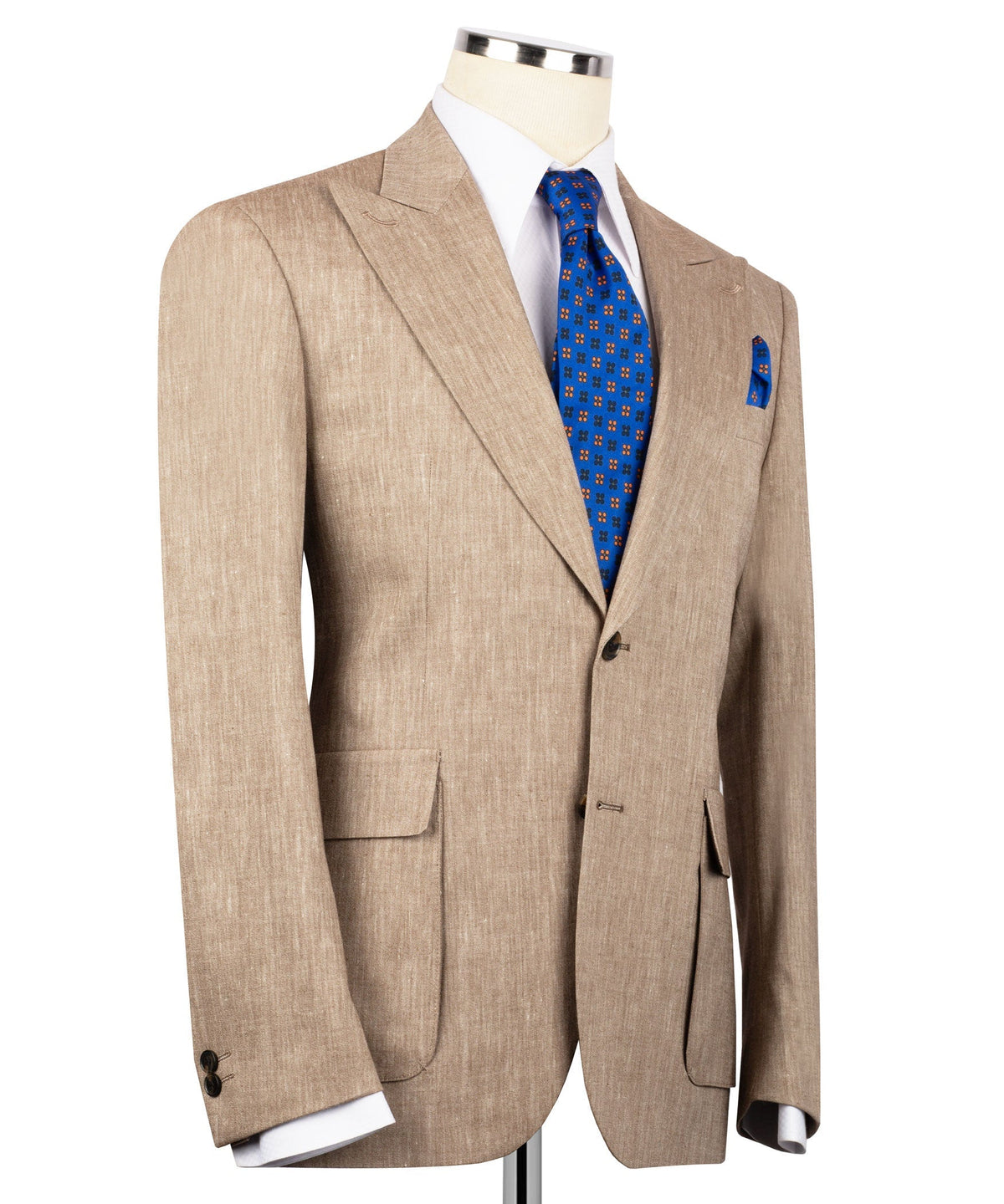 Tan linen suit jacket with peaked shoulders, flap pockets, blue tie and folded pocket square