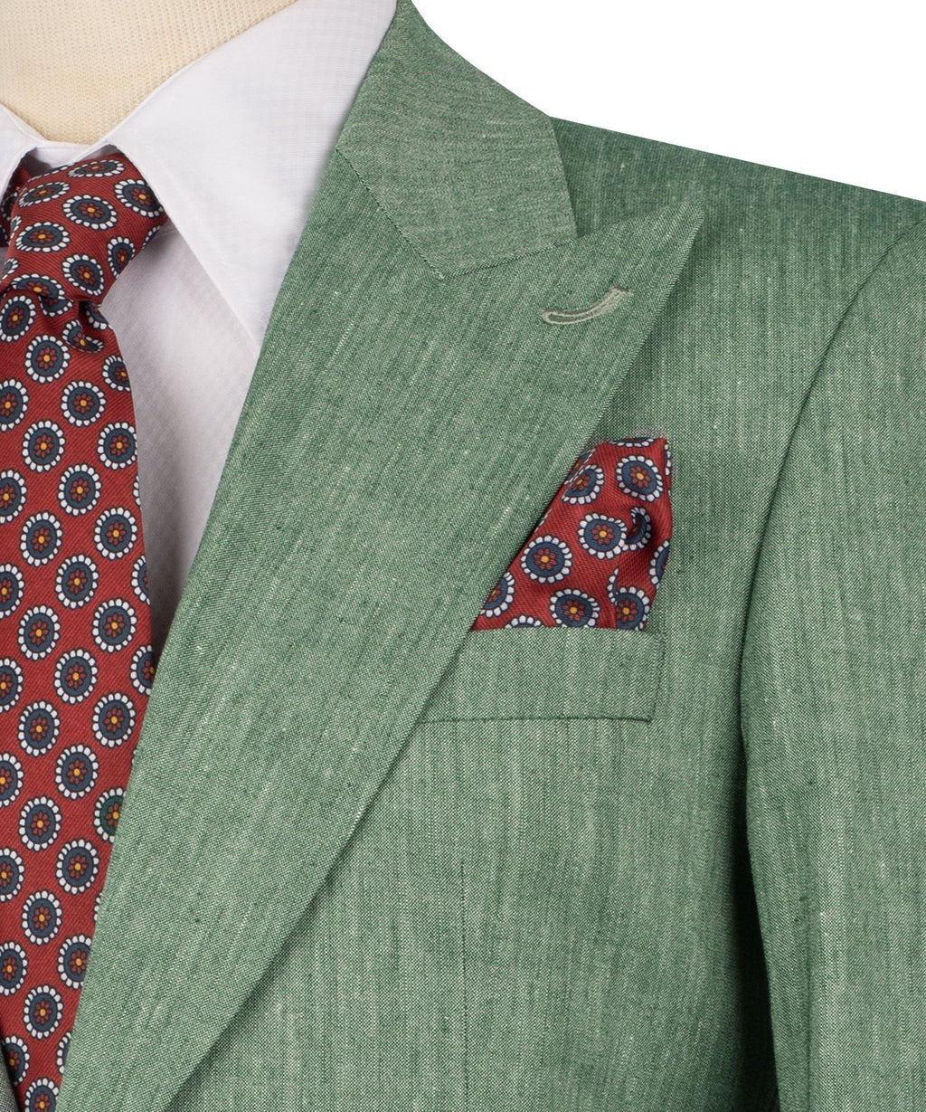 Close-up: green linen blazer with flap pocket and red patterned pocket square