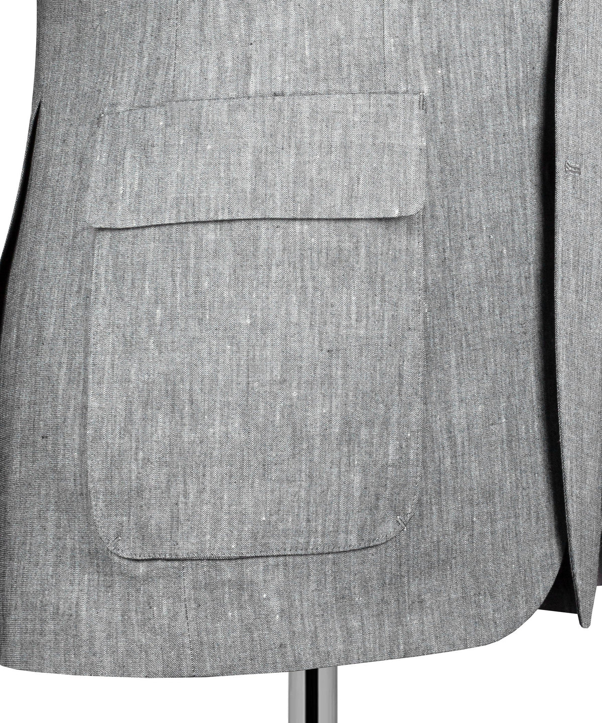 Gray suit jacket front pocket detail with flap and single button