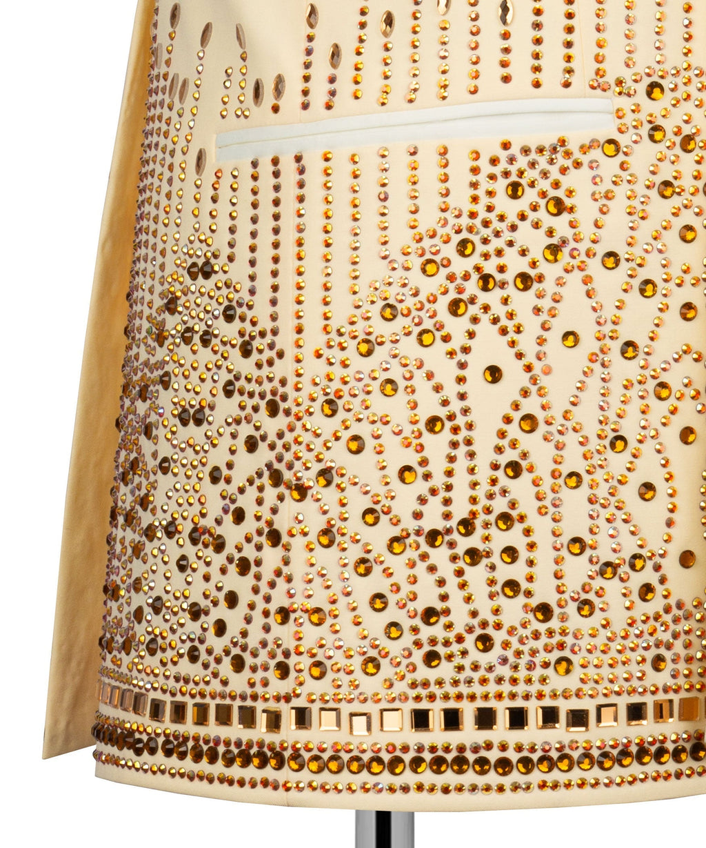 Close-up of yellow jacket hem with gold stone embroidery and decorative border