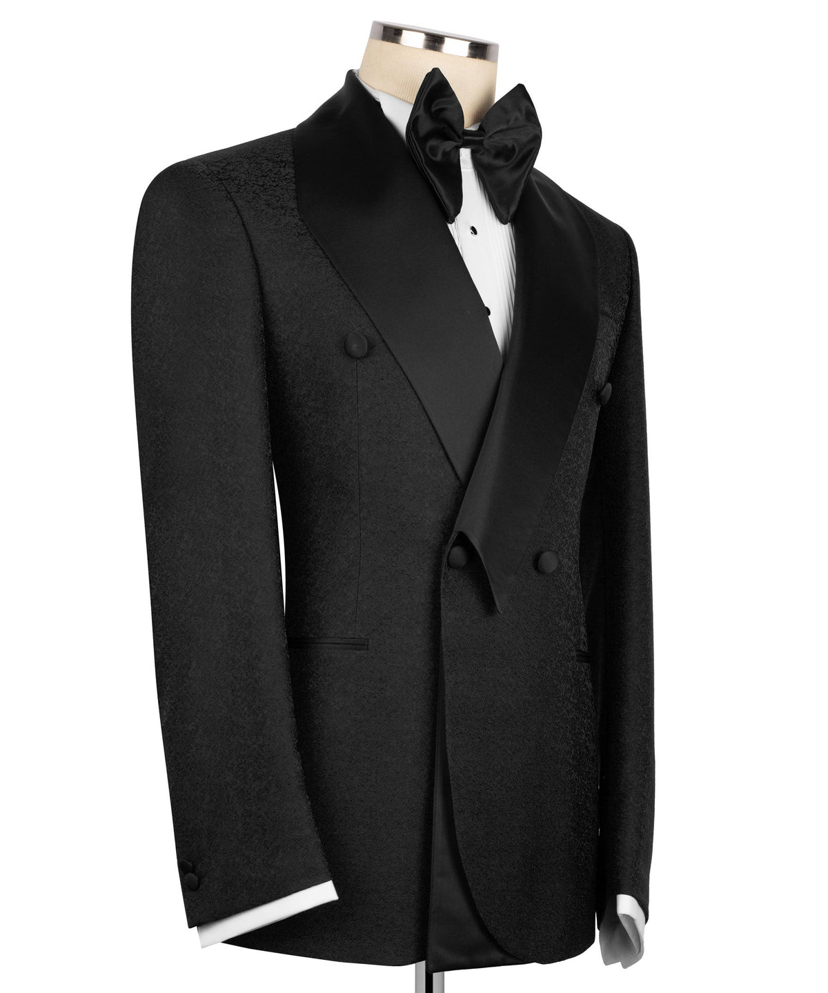 Black tuxedo blazer with geometric shawl collar, bow tie, and vest; side view
