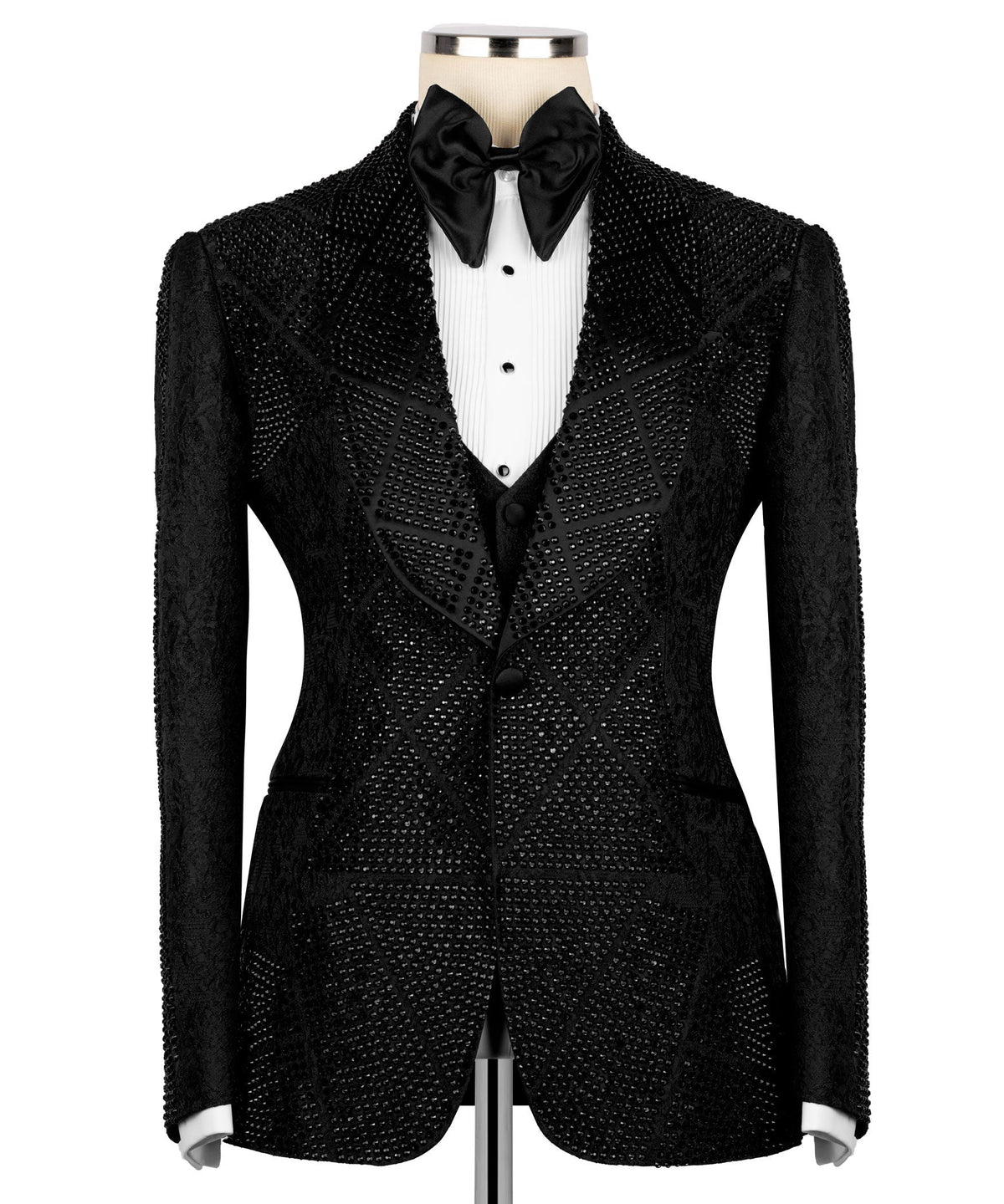 Front view of black stone-embroidered tuxedo jacket with satin bow tie and dark waistcoat
