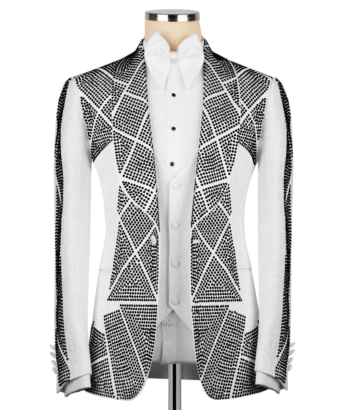 White tuxedo jacket with black dotted stone-style embroidery, paired with white vest and bow tie
