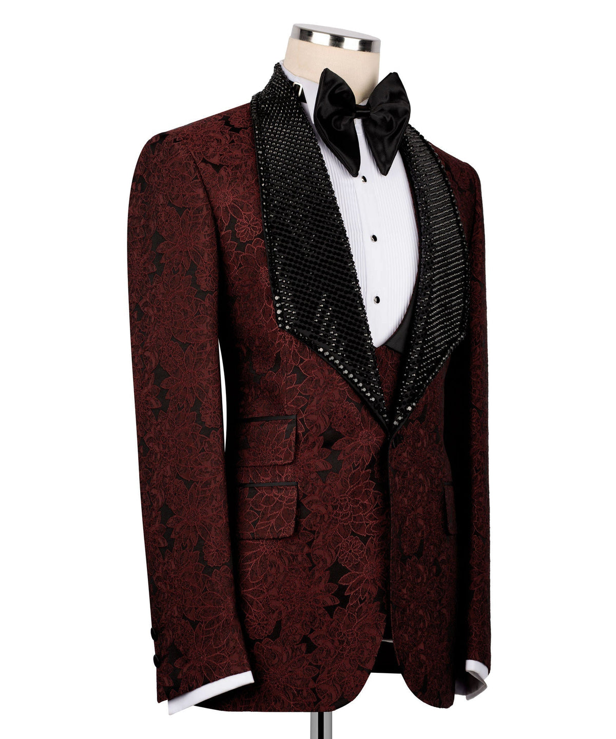 Red embroidered tuxedo jacket with black velvet collar, bow tie, and sequin vest