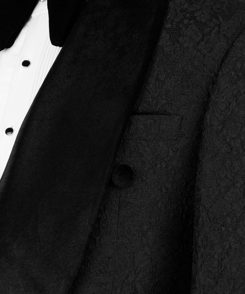 Close-up: black tuxedo jacket lapel, velvet collar, and vest pocket details