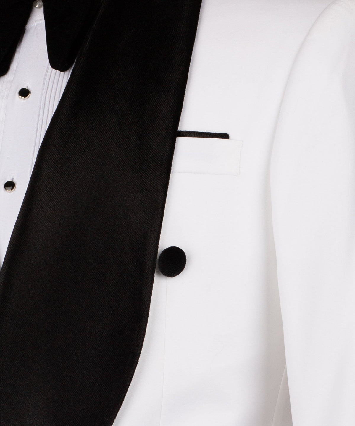 Close-up of black velvet lapel and white vest with buttons