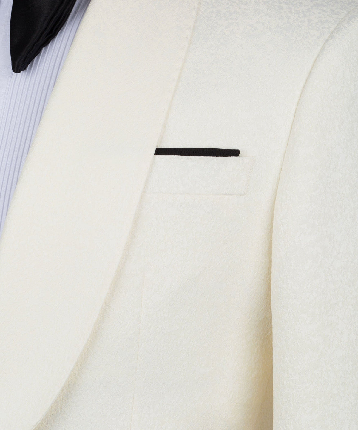 Cream tuxedo jacket lapel and pocket detail with black trim bar