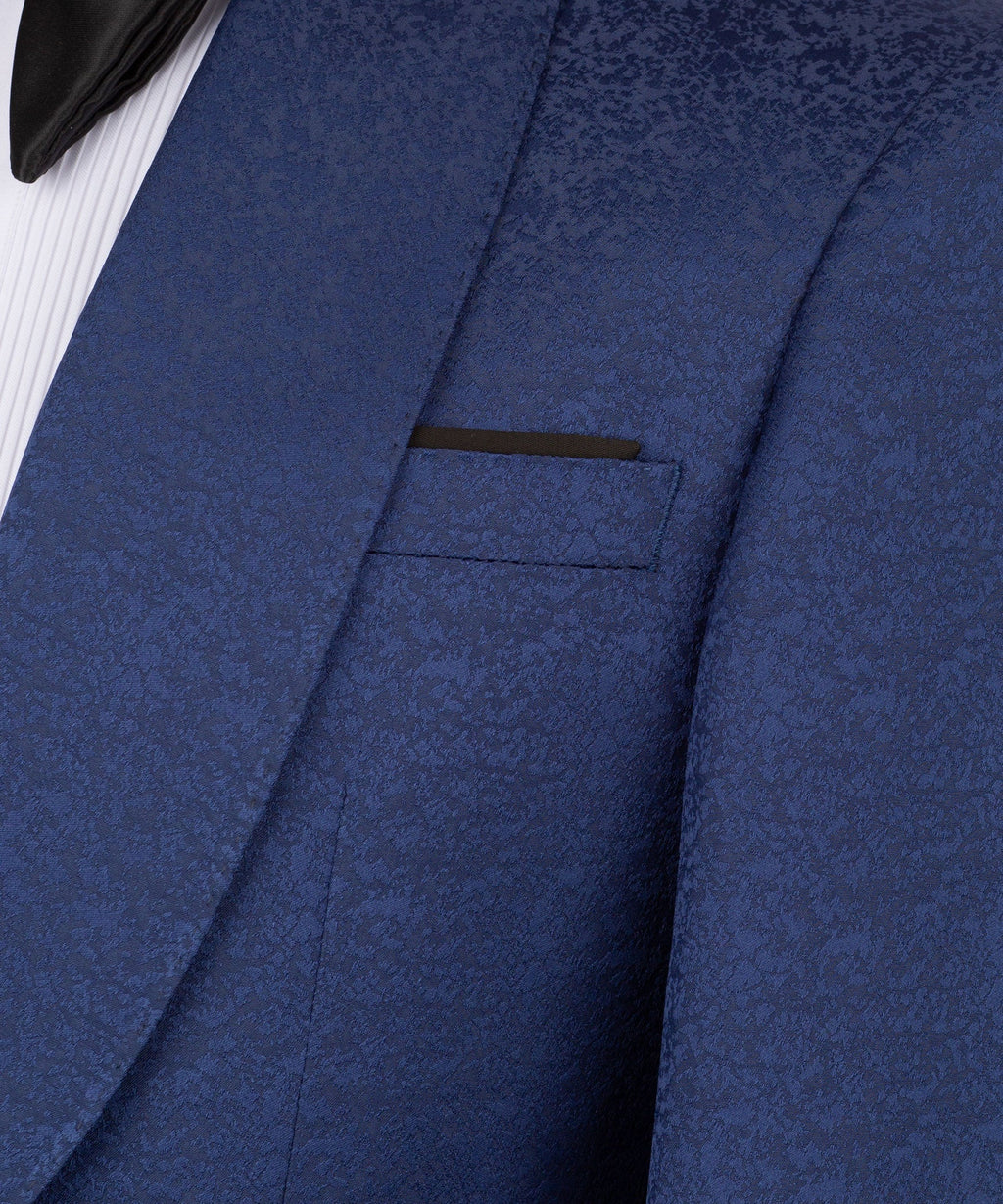 Close-up of navy tuxedo jacket lapel and chest pocket, textured fabric