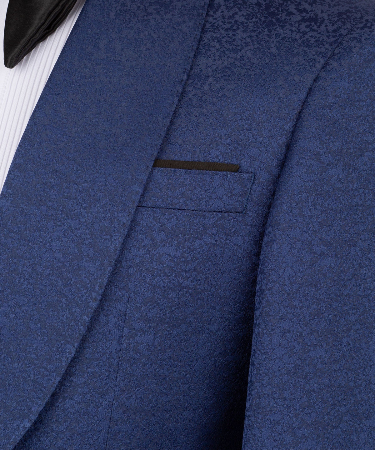 Close-up of navy tuxedo jacket lapel and chest pocket, textured fabric