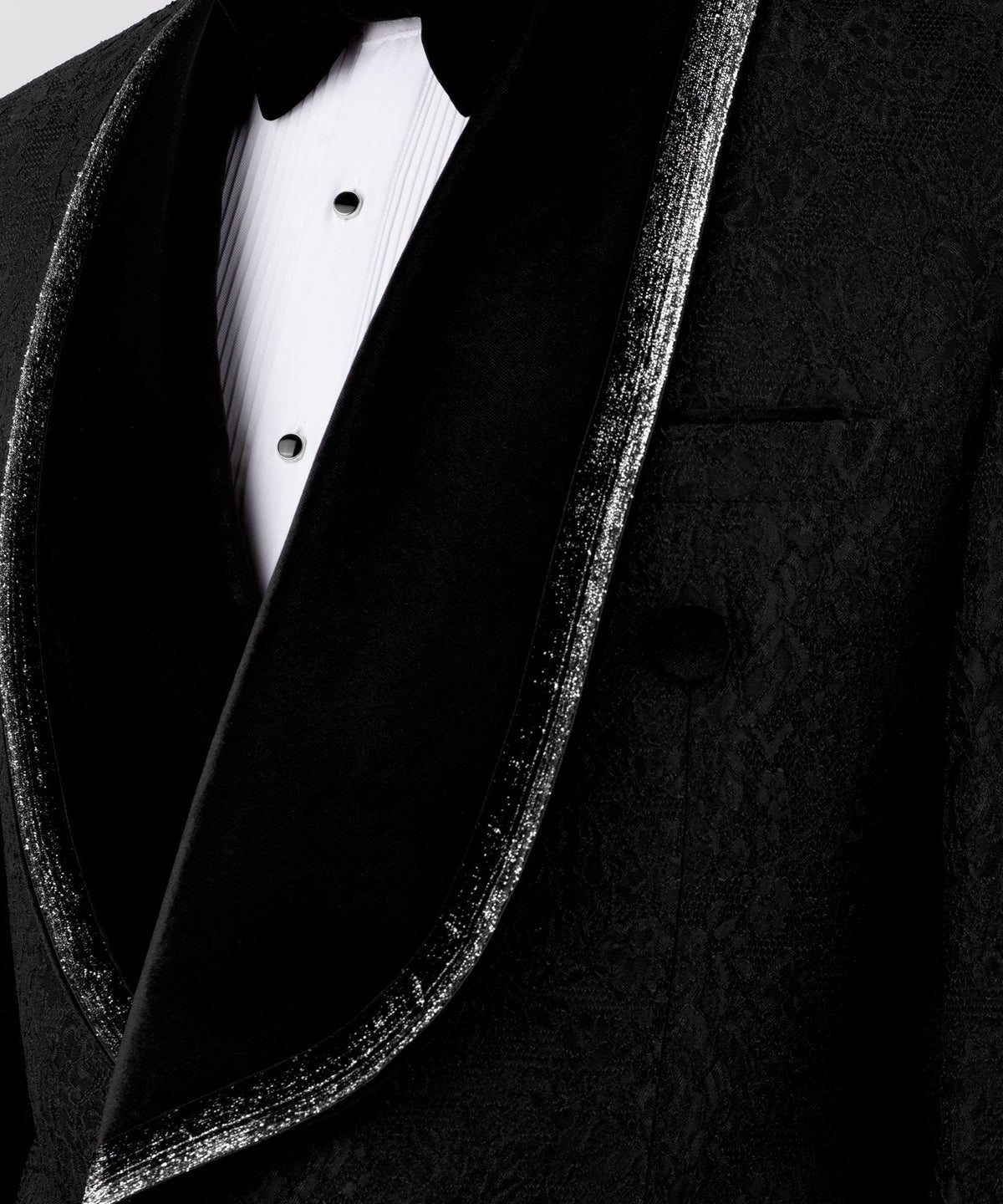 Black velvet lapel close-up with embroidered texture and satin edge trim