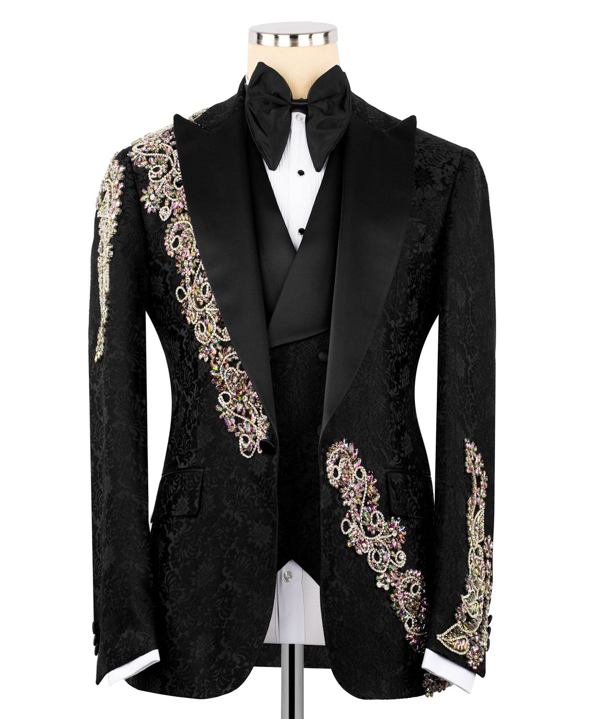 Black tuxedo jacket with black bow tie, white shirt, and jeweled gold/pink trim accents
