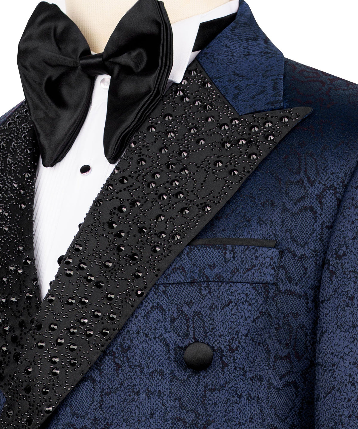 Close-up: black jeweled lapel with bow tie and blue patterned pocket