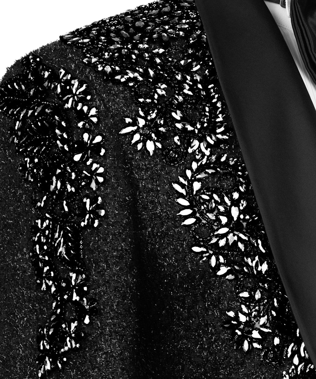 Close-up of black stone-embroidered floral pattern on tuxedo jacket fabric