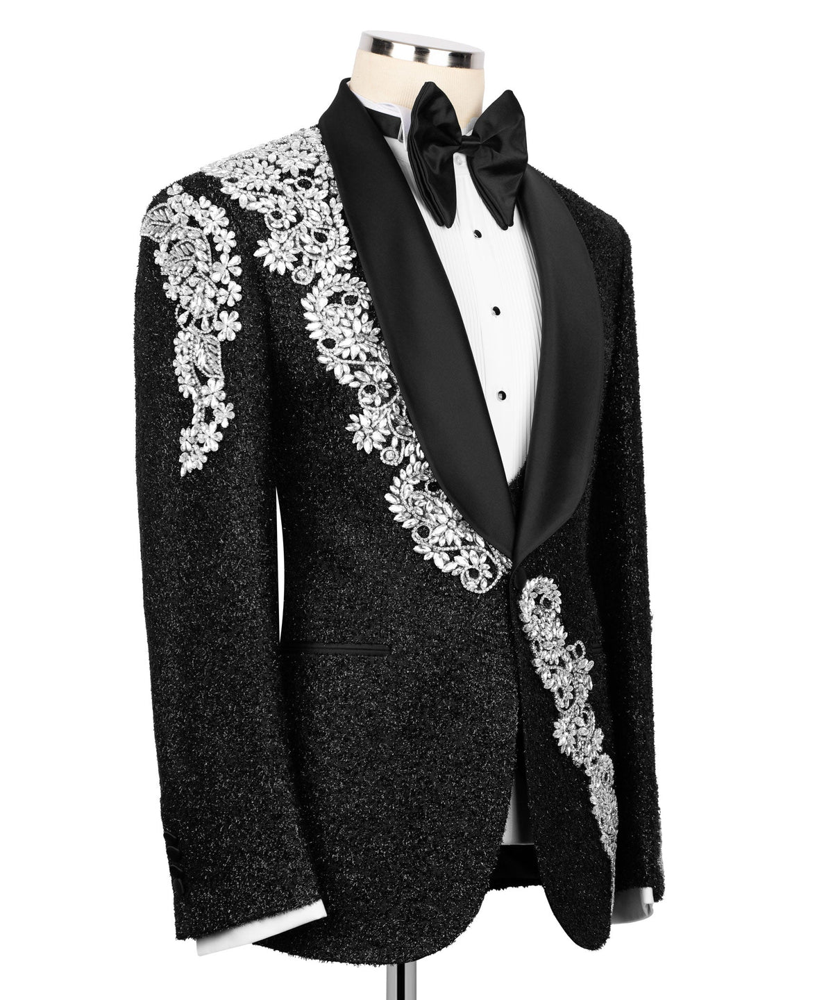 Black tuxedo jacket with silver embroidered panel and cuffs over white vest, bow tie