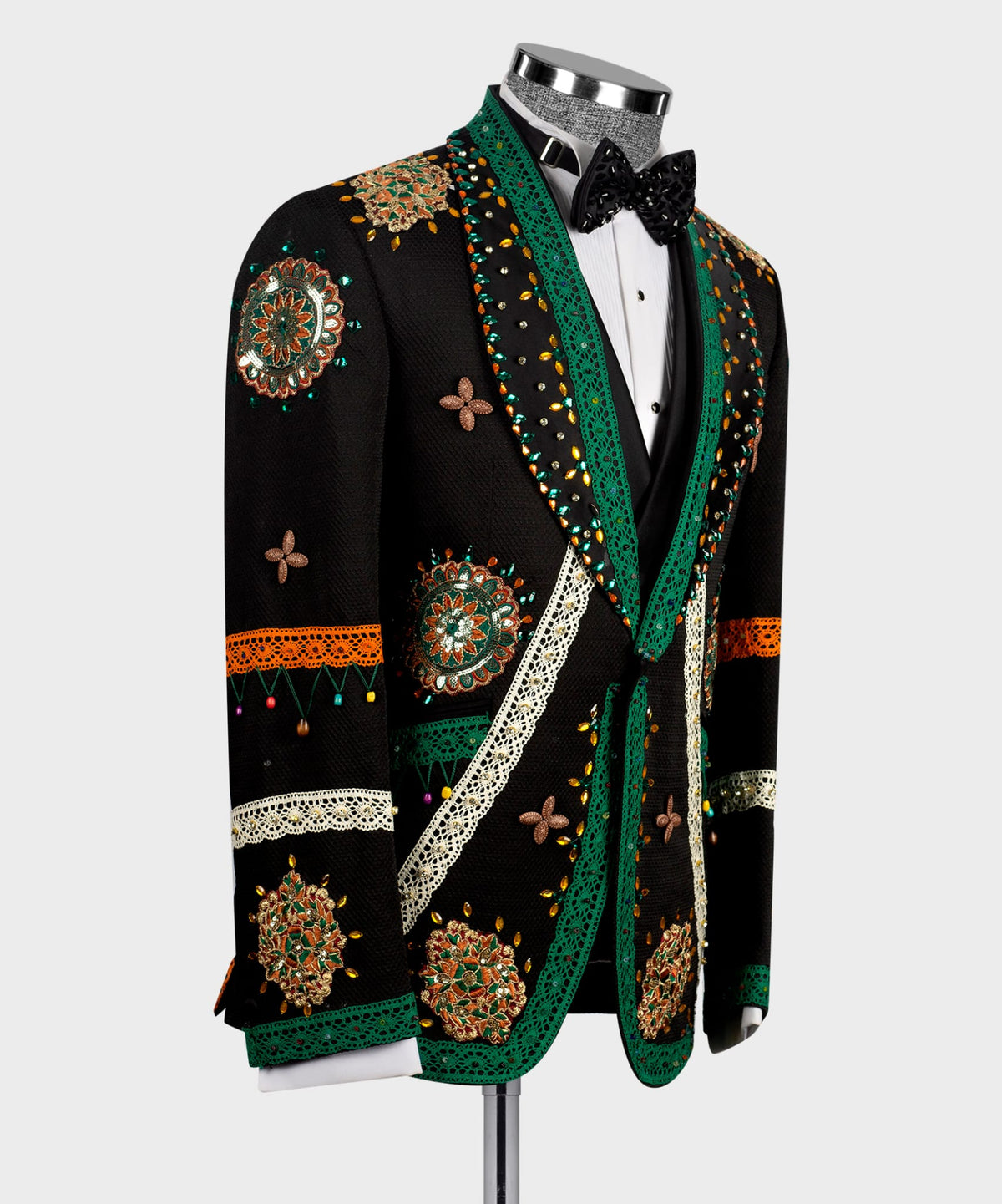 Black tuxedo jacket with green trim, butterfly motifs, and crystal-style embellishments